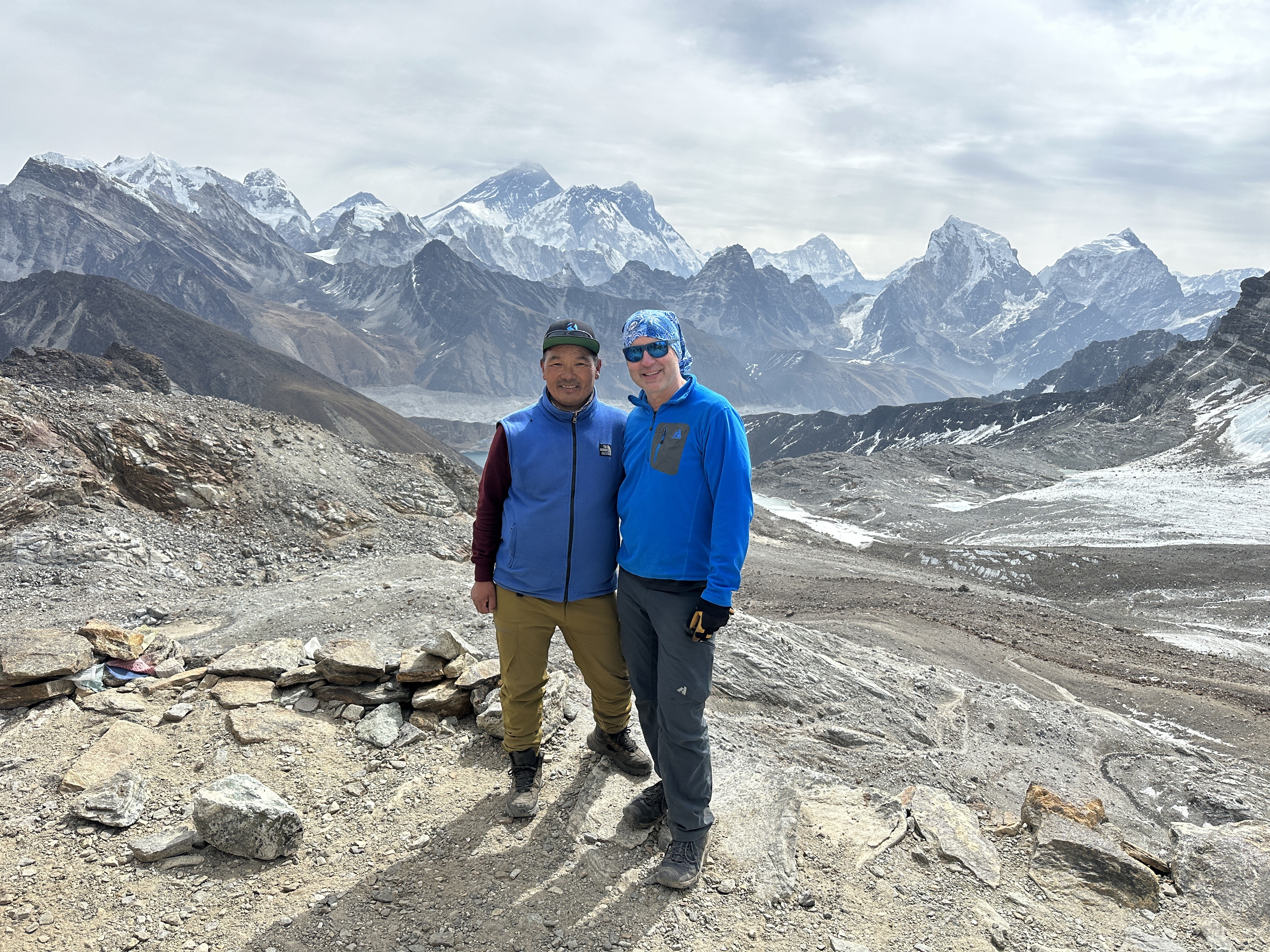 Derik and his Third Rock guide at a high pass on the Gokyo + Renjo La trek, with Everest, Lhotse, Makalu and Cho Oyu visible behind.
