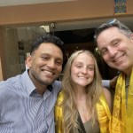 Derik, his daughter Camryn, and Naba of Third Rock Adventures at a Kathmandu hotel with traditional khata scarves.
